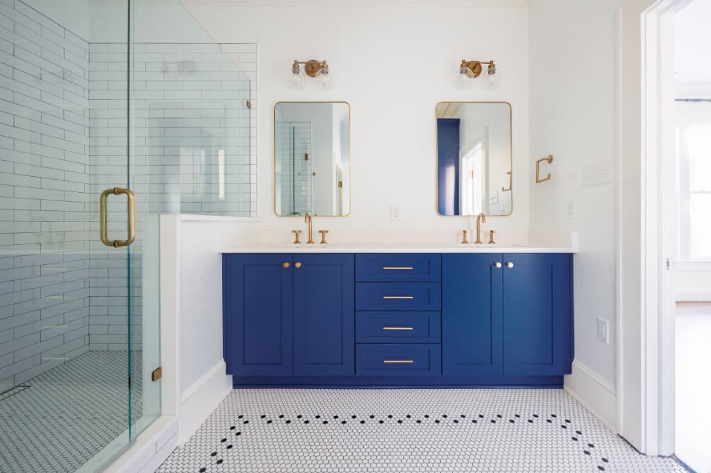 double vanity with gold mirror and lighting